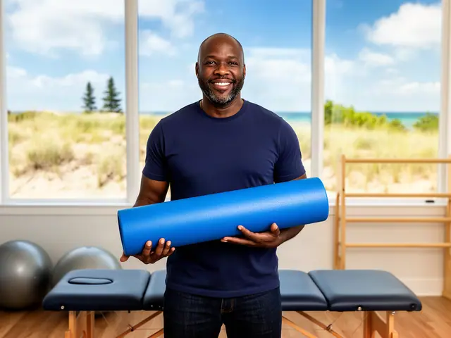 A therapy-clinic owner holding a long blue foam roller beside padded treatment tables.