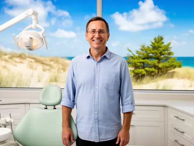 A dentist standing beside a dental chair.